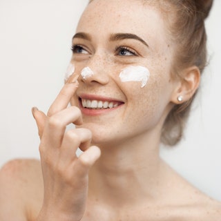 Photos of woman applying white cream to nose and cheeks standing in front of white background