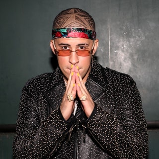 bad bunny with black printed jacket and brown sunglasses