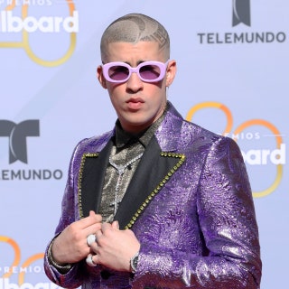 bad bunny on the red carpet with purple suit jacket and lavender sunglasses at the 2018 latin billboard awards with